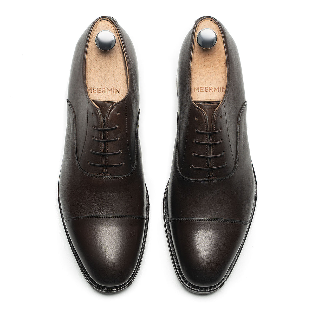 Meermin brown silkcalf cap-toe Oxfords, top-down view of both shoes on shoe trees, showing lace detail and toe caps