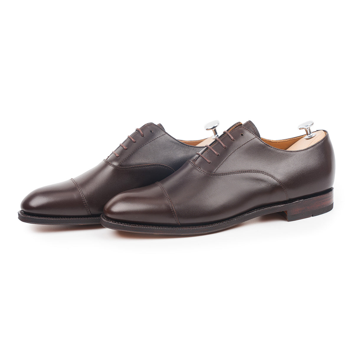 Meermin espresso antique calf cap-toe Oxfords, angled front view on shoe trees, showing flex Goodyear welted soles