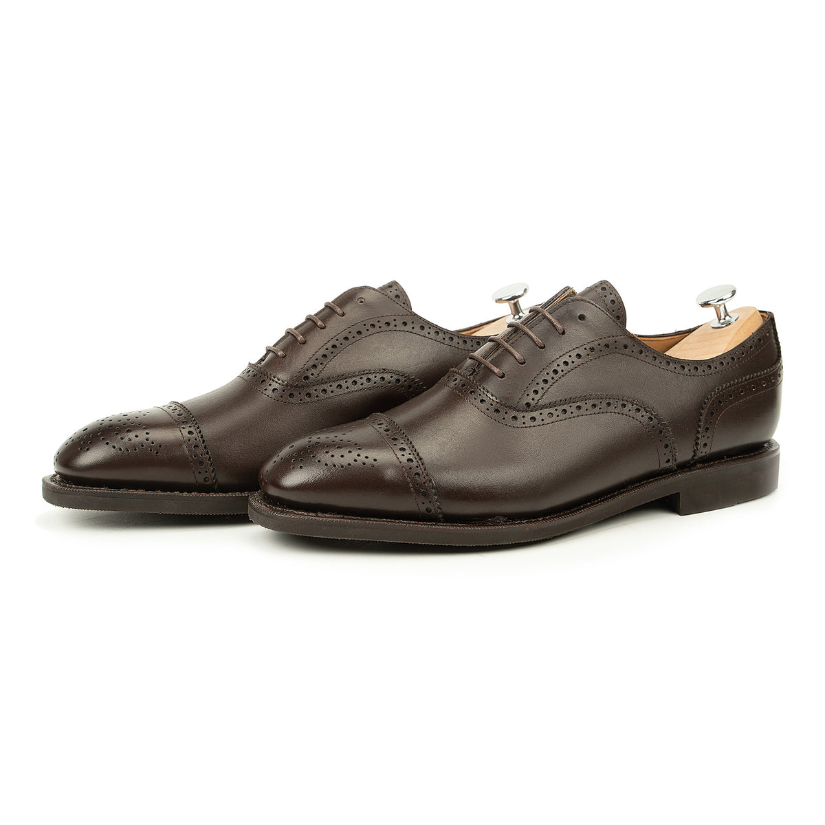 Meermin brown boxcalf full brogue Oxfords, paired three-quarter view on shoe trees, showing cap-toe perforation detail