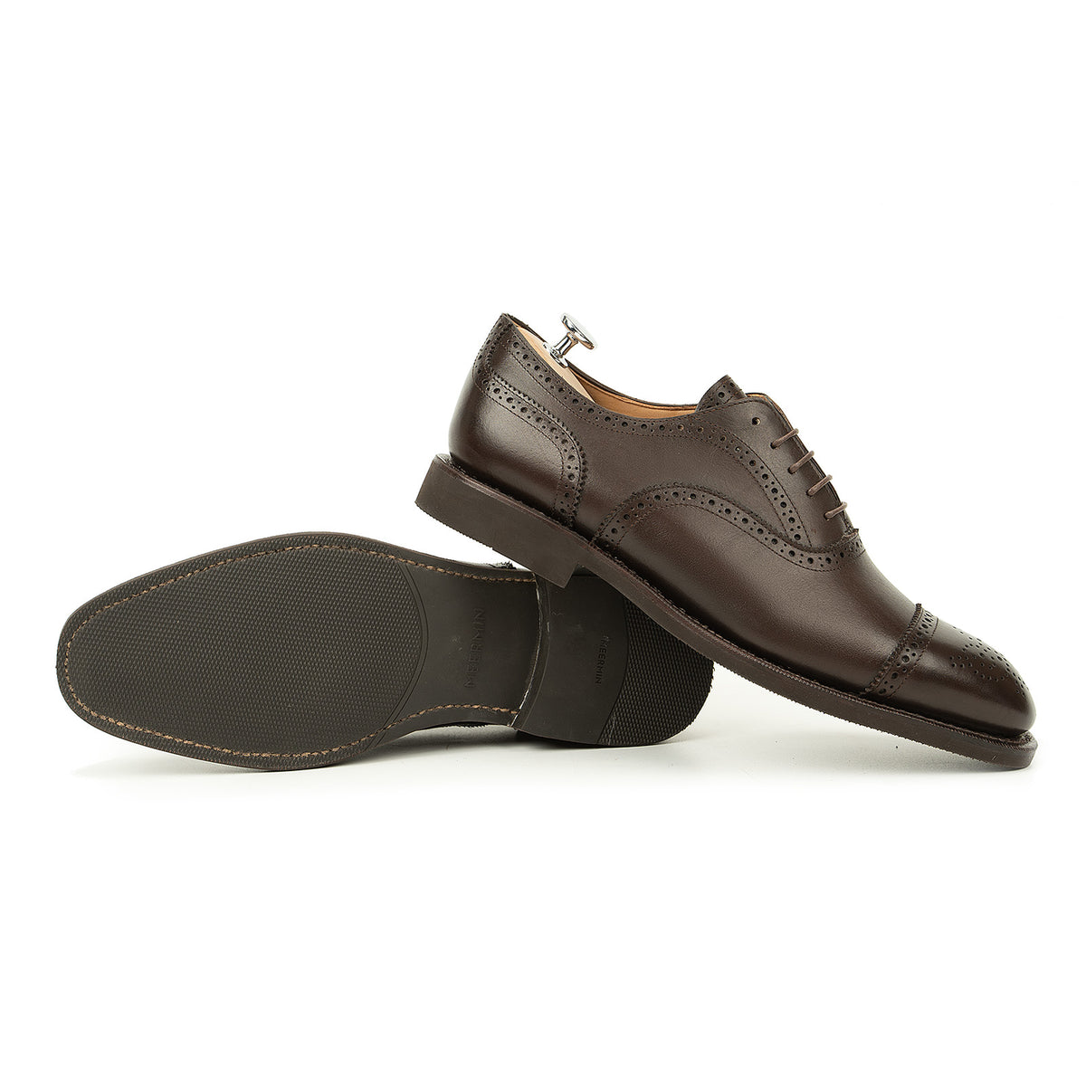 Meermin brown boxcalf full brogue Oxford pair, one shoe on shoe tree, the other tipped to show diamond latex rubber sole
