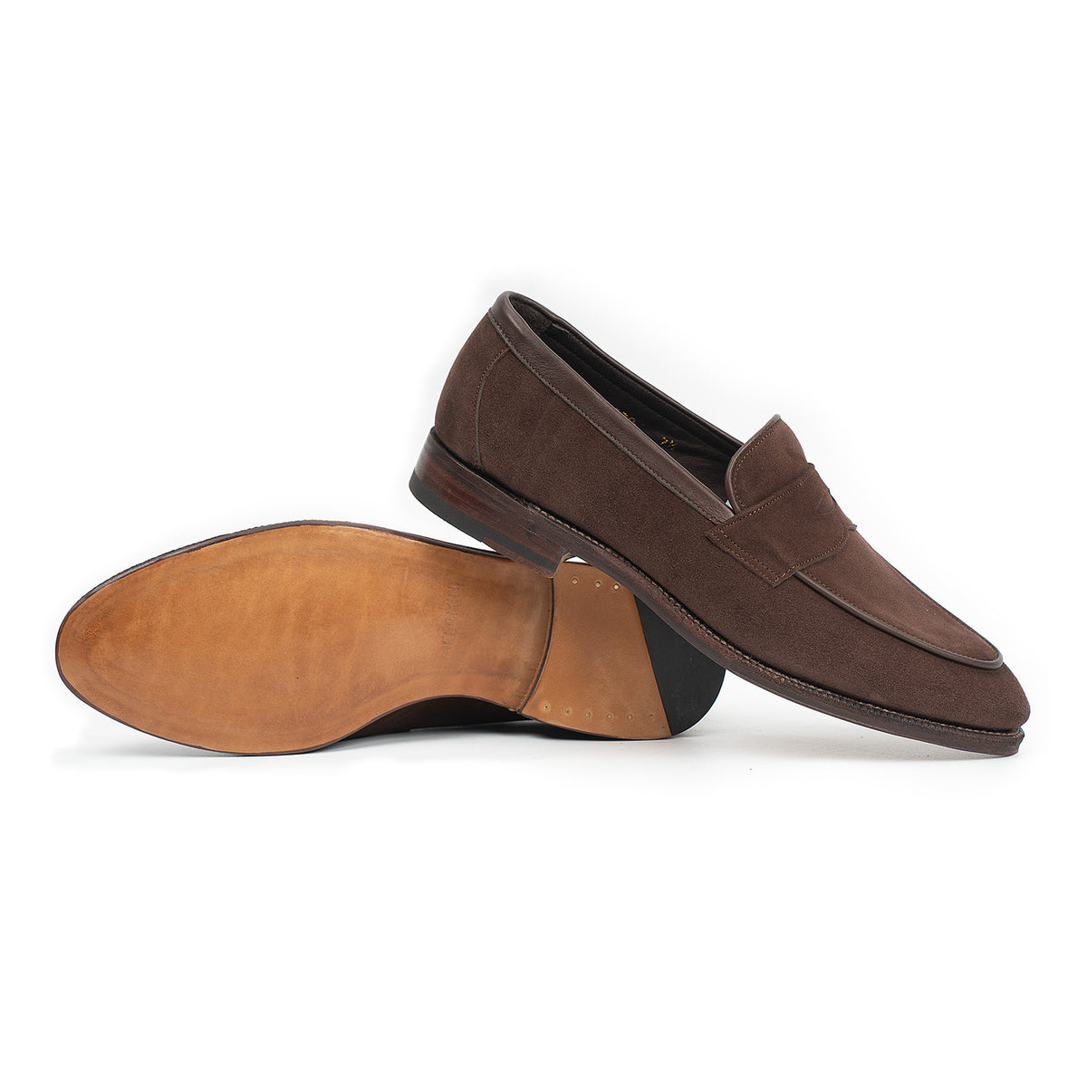 Meermin brown suede penny loafer pair, side profile with one shoe overturned to show tan leather sole and stacked heel