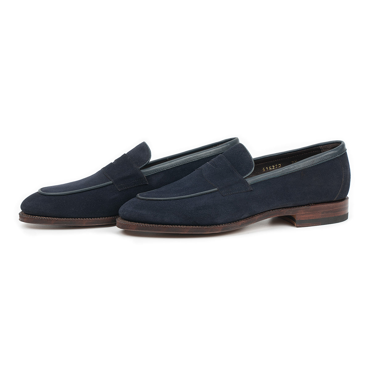 Meermin navy suede penny loafers, three-quarter side view showing piping apron detail and leather sole
