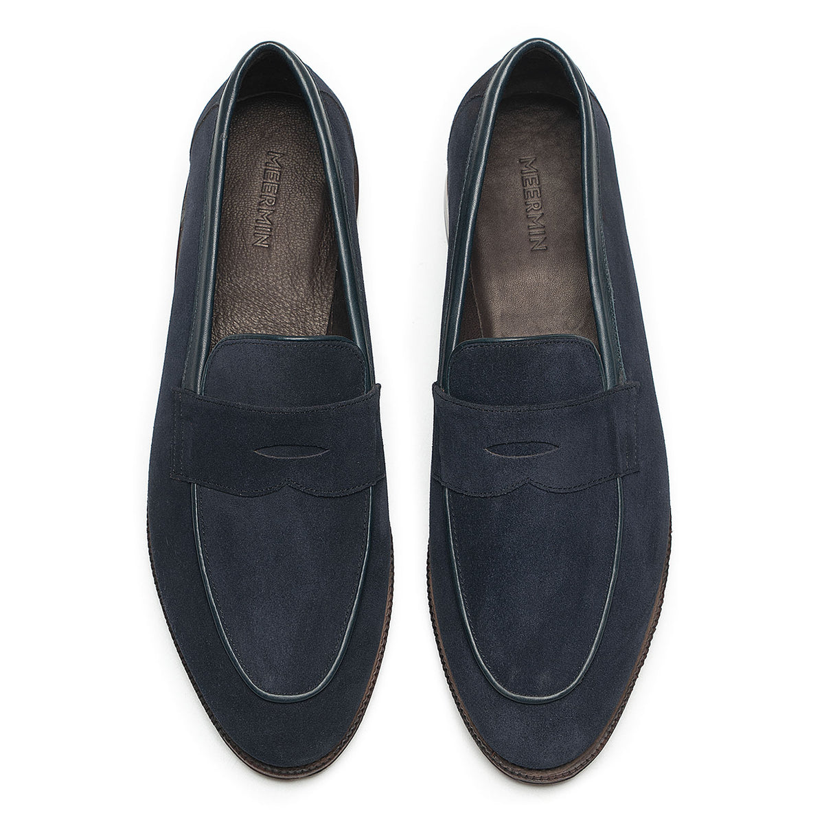 Meermin navy suede penny loafers, top-down view of both shoes showing piping apron detail and dark leather insoles
