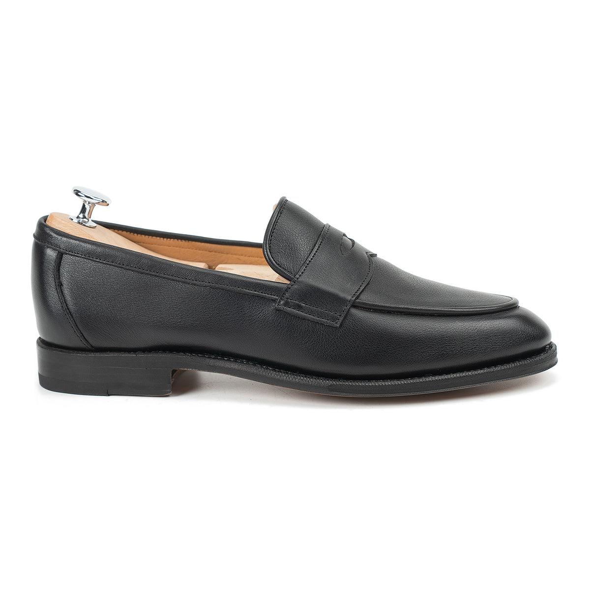 Meermin black softcalf penny loafer, side profile with shoe tree inserted, showing apron seam and leather sole