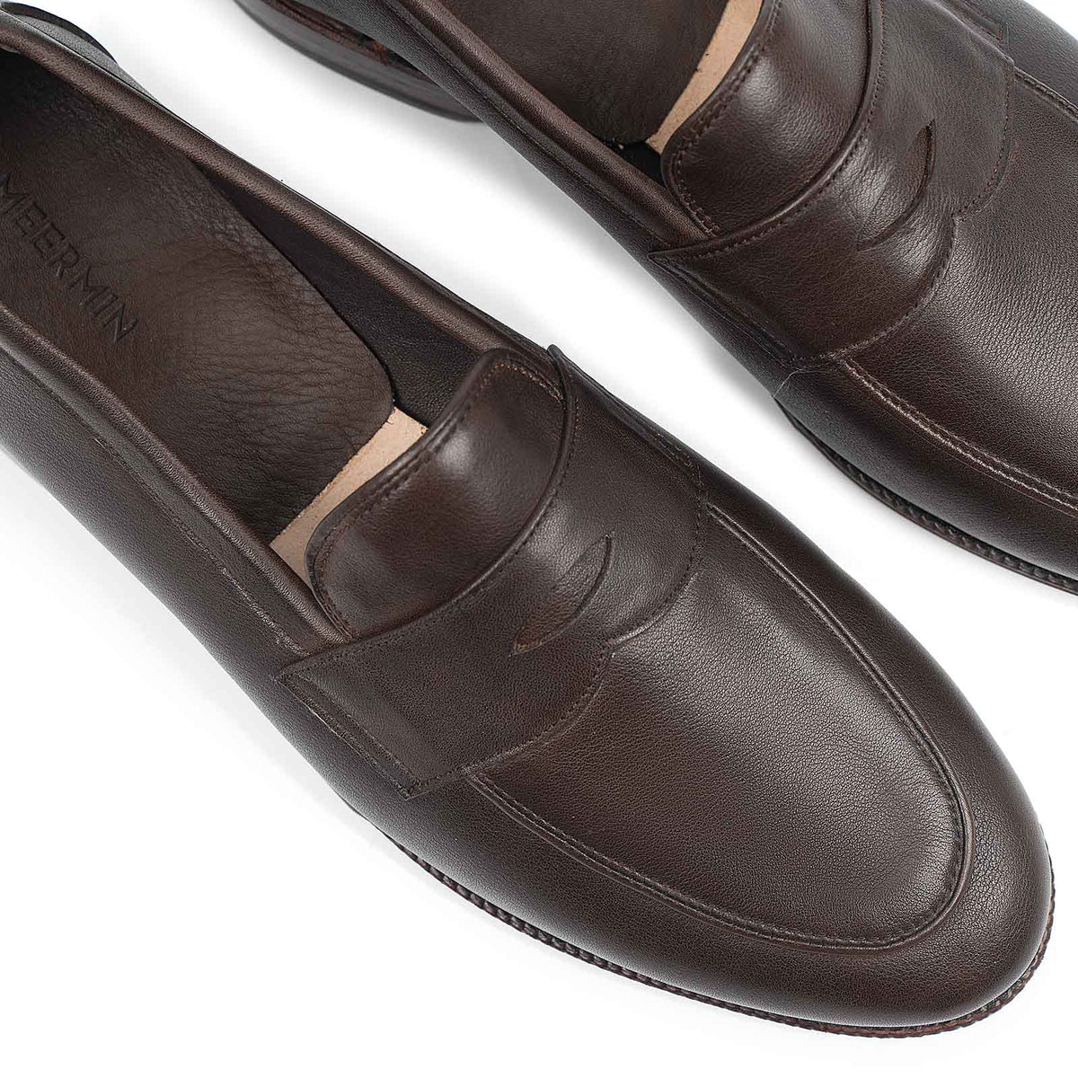 Meermin brown softcalf penny loafers, close-up top view of the piped apron and toe detail on both shoes