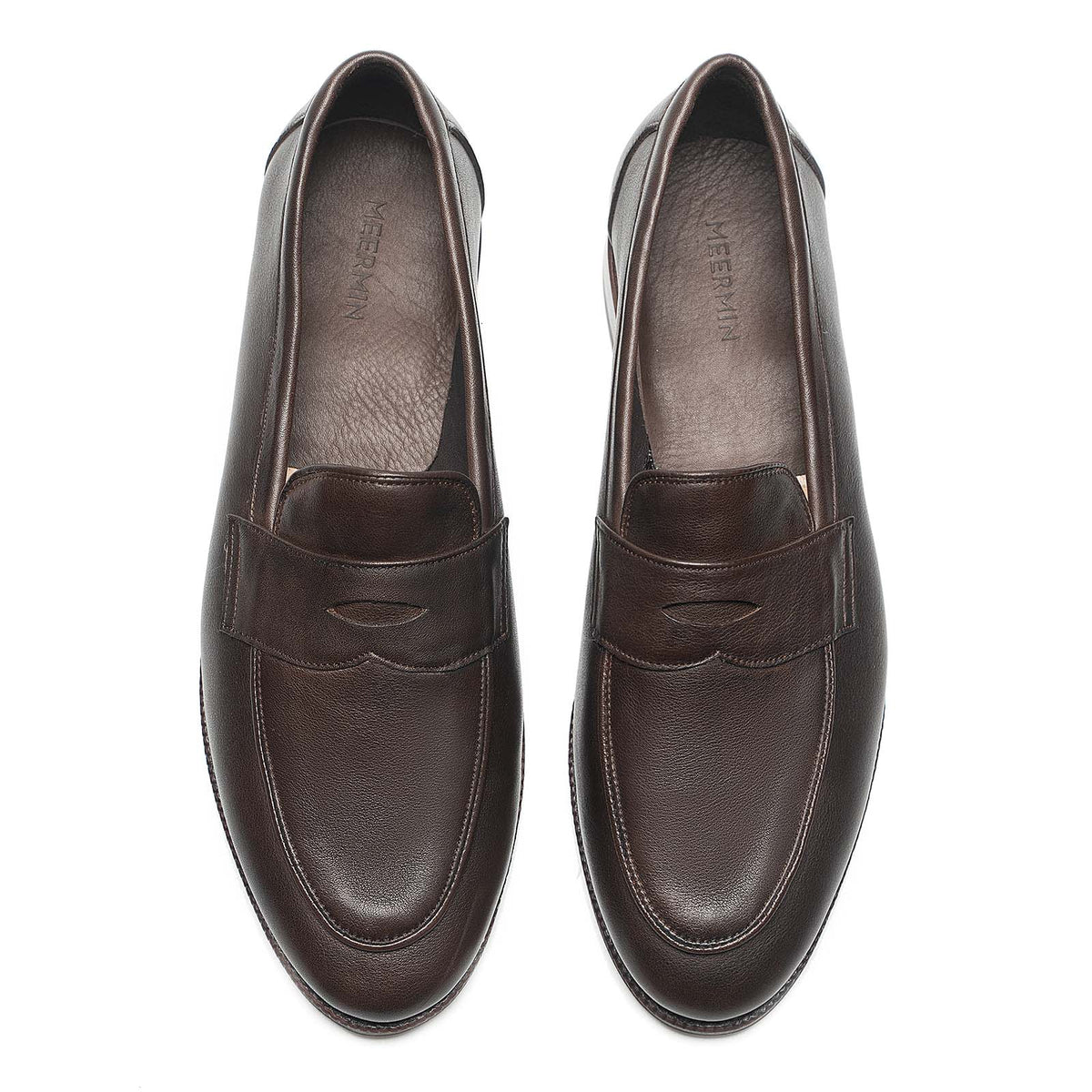 Meermin brown softcalf penny loafers, top-down view of both shoes showing piped apron and moc-toe stitching