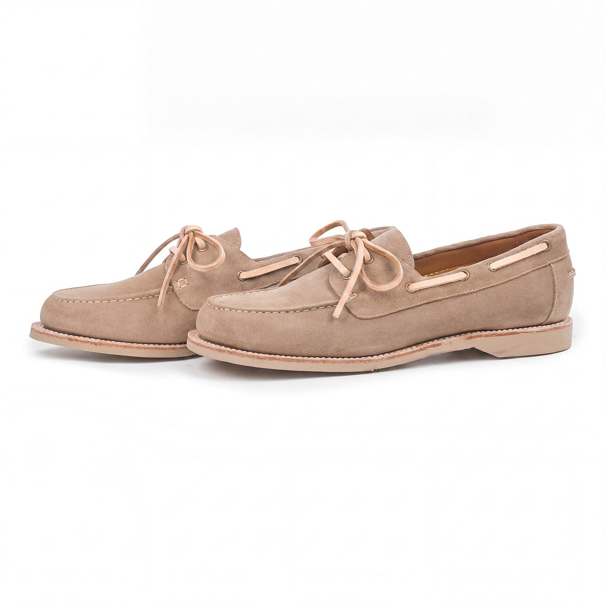 Meermin taupe suede boat shoes, three-quarter side view showing veg-tan leather laces and taupe latex sole