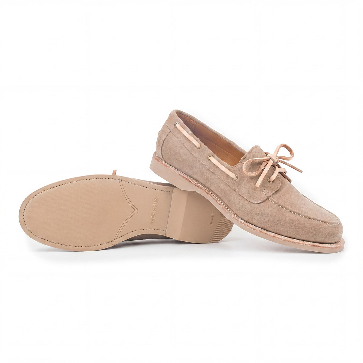 Meermin taupe suede boat shoe pair, side profile with one shoe overturned showing the taupe latex sole and heel stack