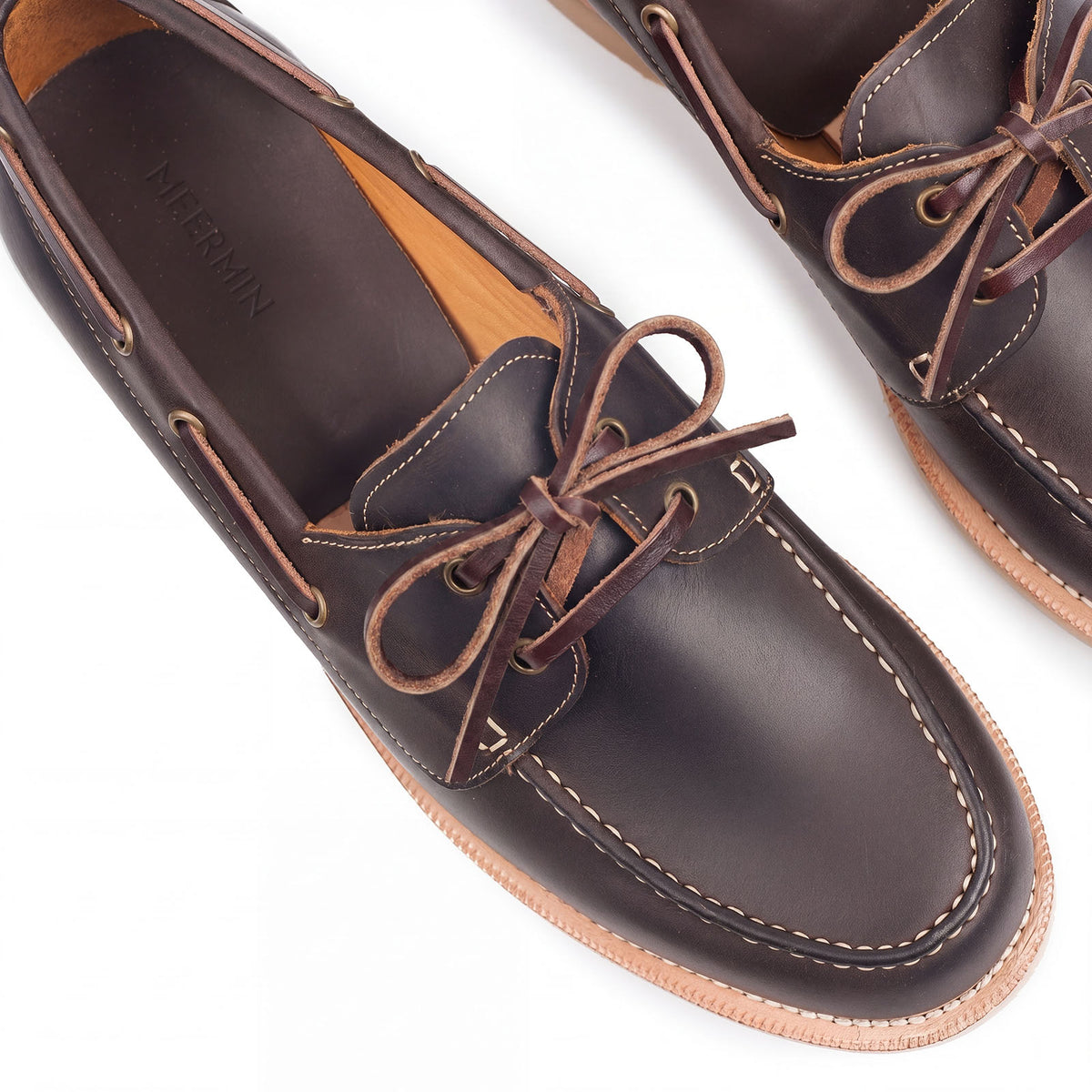 Meermin brown waxy calf deck shoes, close-up top view of laced vamp with veg-tan leather ties and brass eyelets