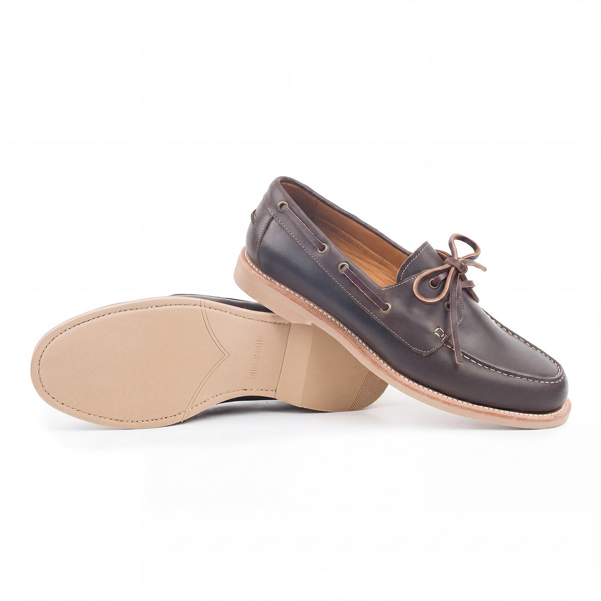 Meermin brown waxy calf boat shoe pair, one resting sole-up against the other, showing taupe latex sole and heel