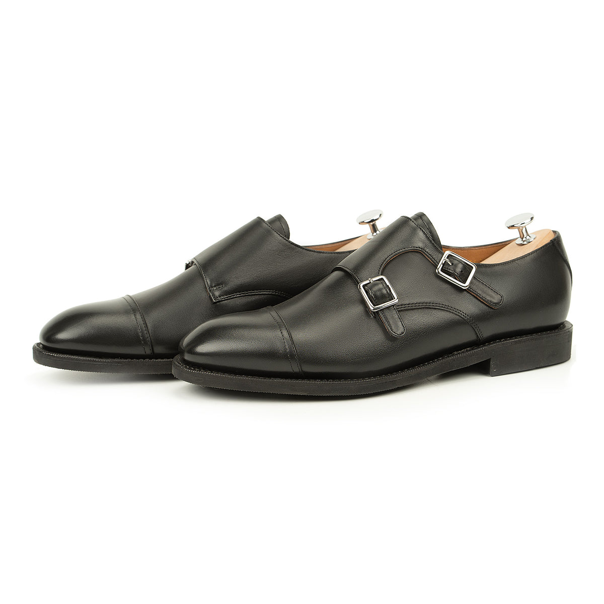 Meermin black silkcalf double monkstrap shoes, angled three-quarter view on shoe trees, showing cap-toe and buckle straps