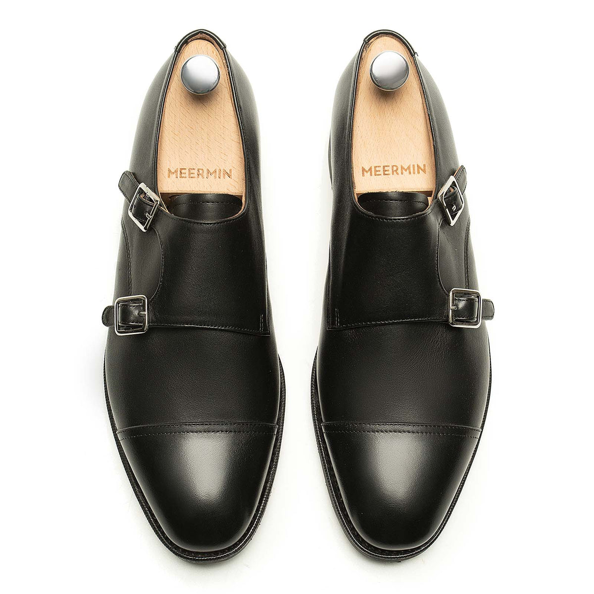 Meermin black silkcalf double monkstrap shoes, top-down view on shoe trees, showing cap toes and dual buckle straps