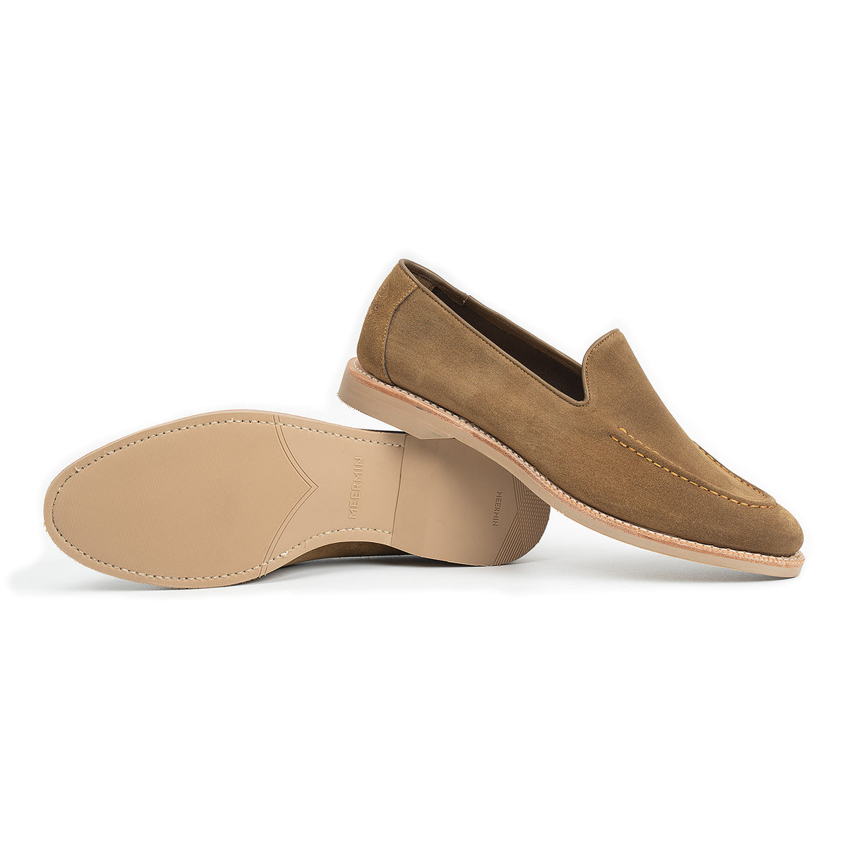 Meermin Atacama suede unlined loafer pair, side profile with one shoe overturned to reveal the tonal taupe rubber sole