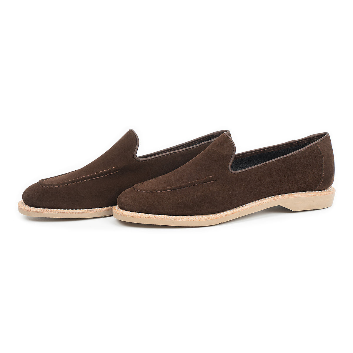 Meermin brown suede unlined loafers, three-quarter side view showing hand-sewn apron stitching and contrasting taupe rubber sole