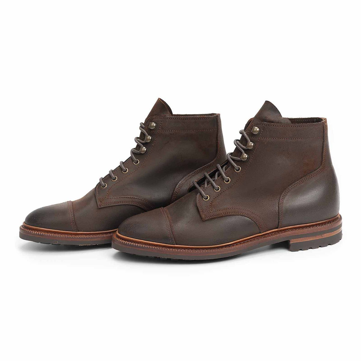 Meermin rust waxy commander cap-toe boots, pair shown at three-quarter angle, cap toe and lace-up shaft with leather sole in focus