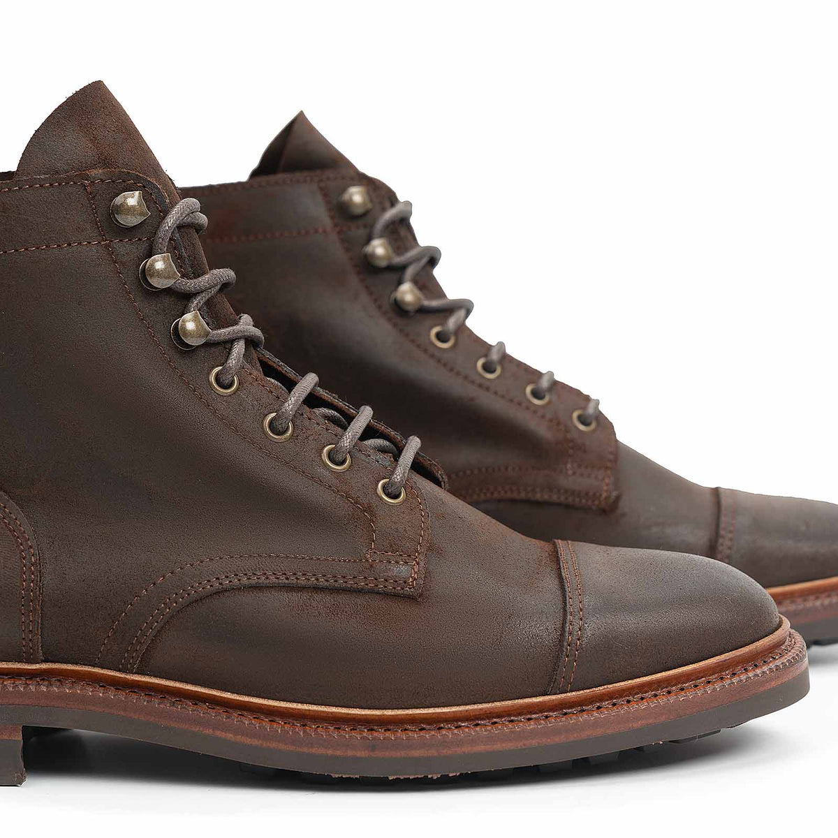 Meermin waxy commander cap-toe boots, close-up side view of cap toe stitching, lacing hardware and welted sole detail