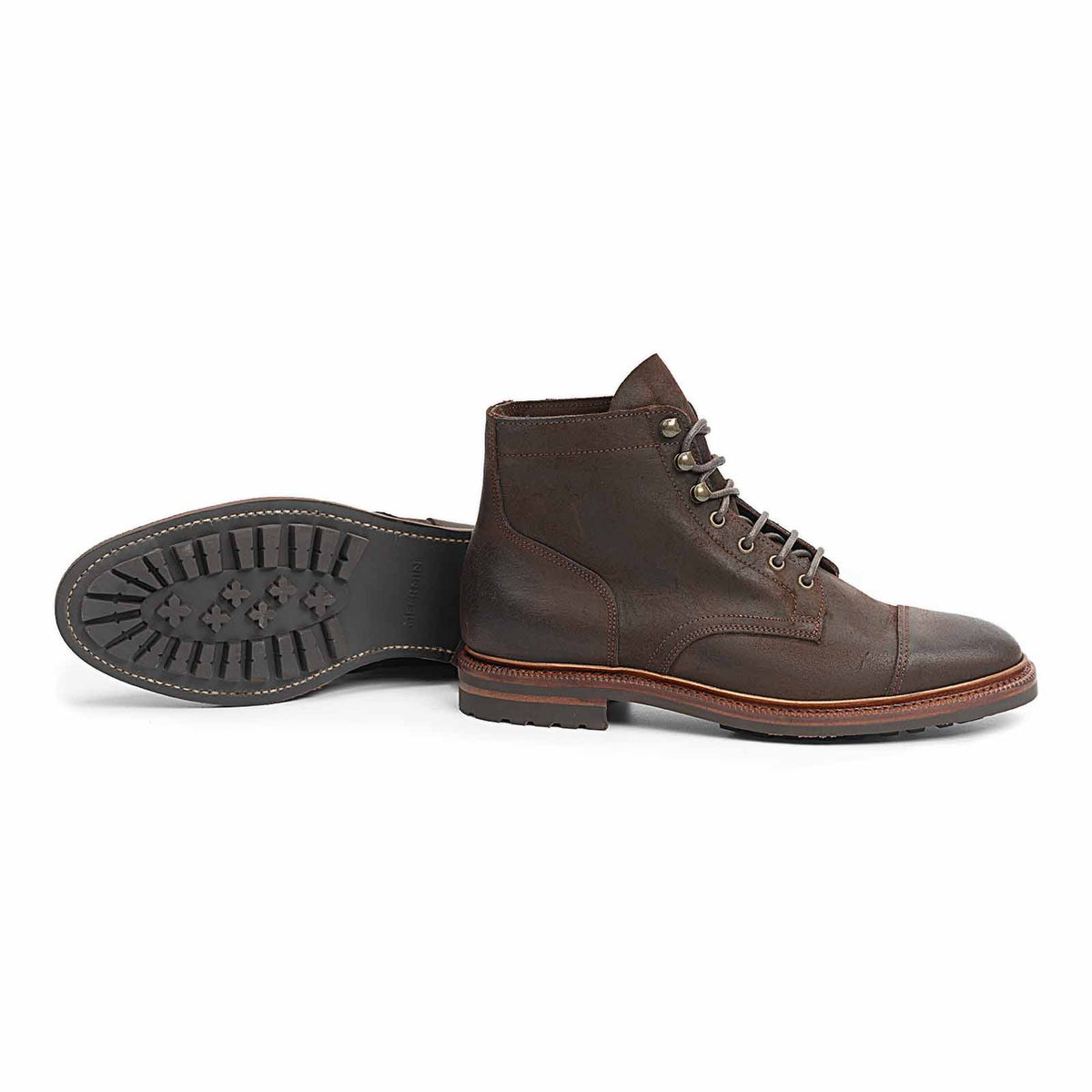 Meermin waxy commander suede cap-toe boot, side profile, paired with its mate shown sole-up to reveal the studded rubber sole