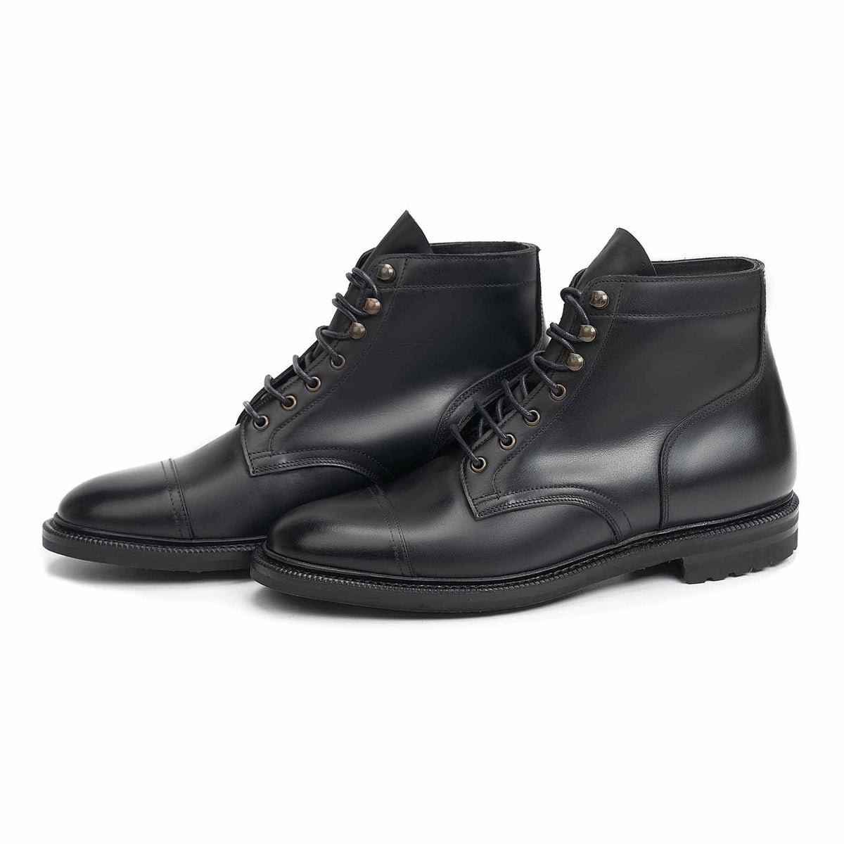 Meermin black waxy calf cap-toe boots, three-quarter view of both pairs showing lace-up front and cap-toe stitching
