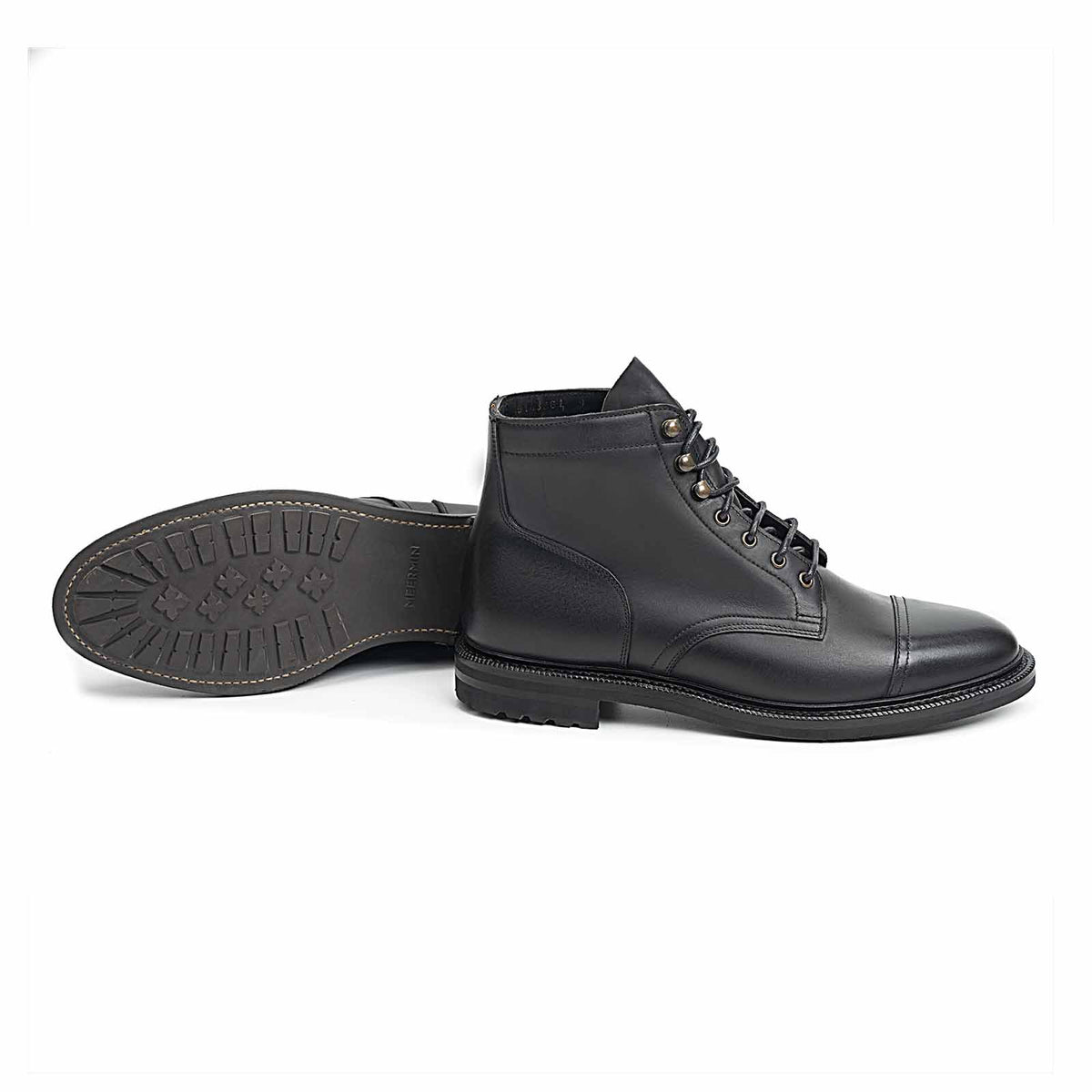 Meermin black waxy calf cap-toe boots, side profile paired with matching sole tread facing up, showing lug outsole pattern