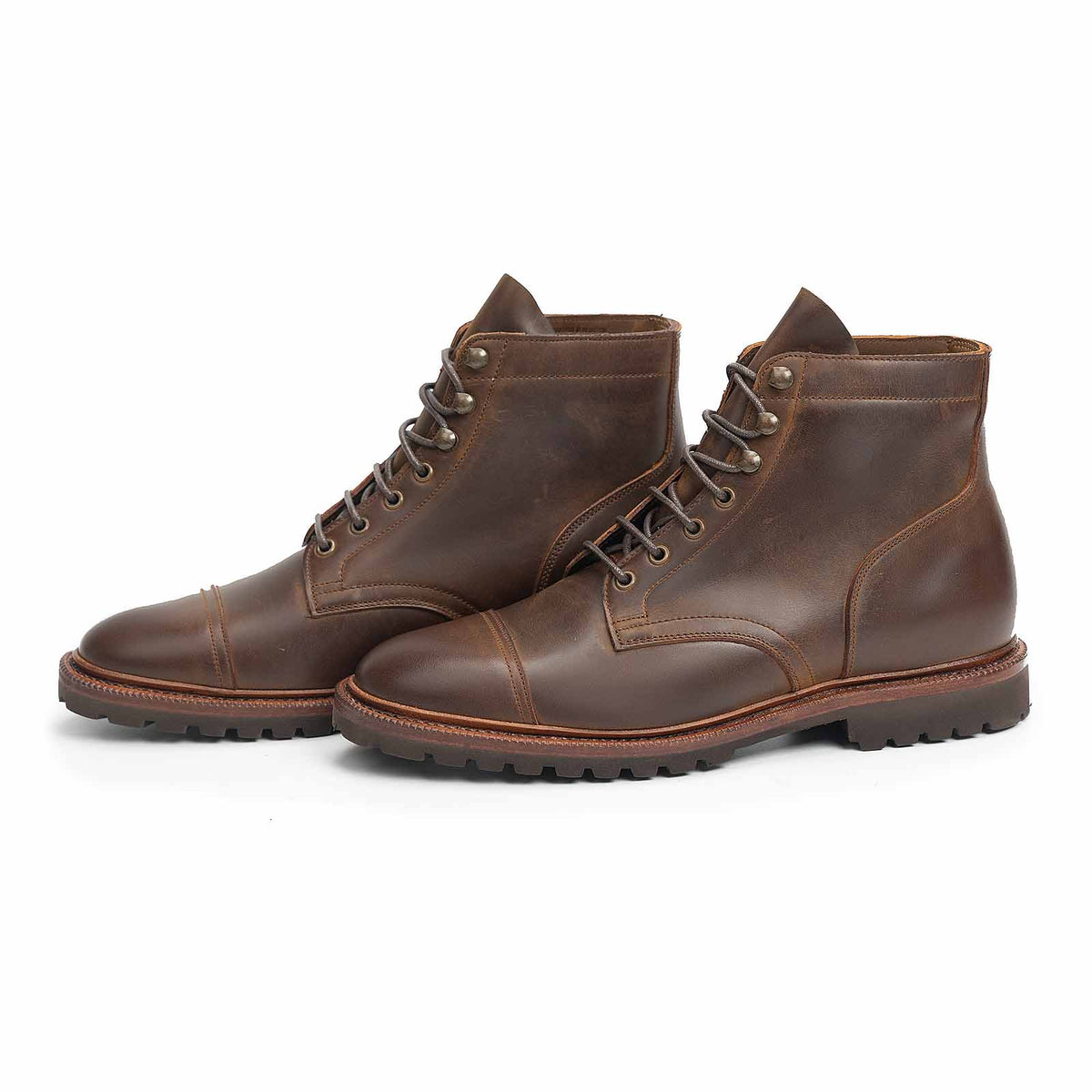 Meermin tobacco waxy calf cap-toe boots, three-quarter front view showing lug soles and lace-up shafts