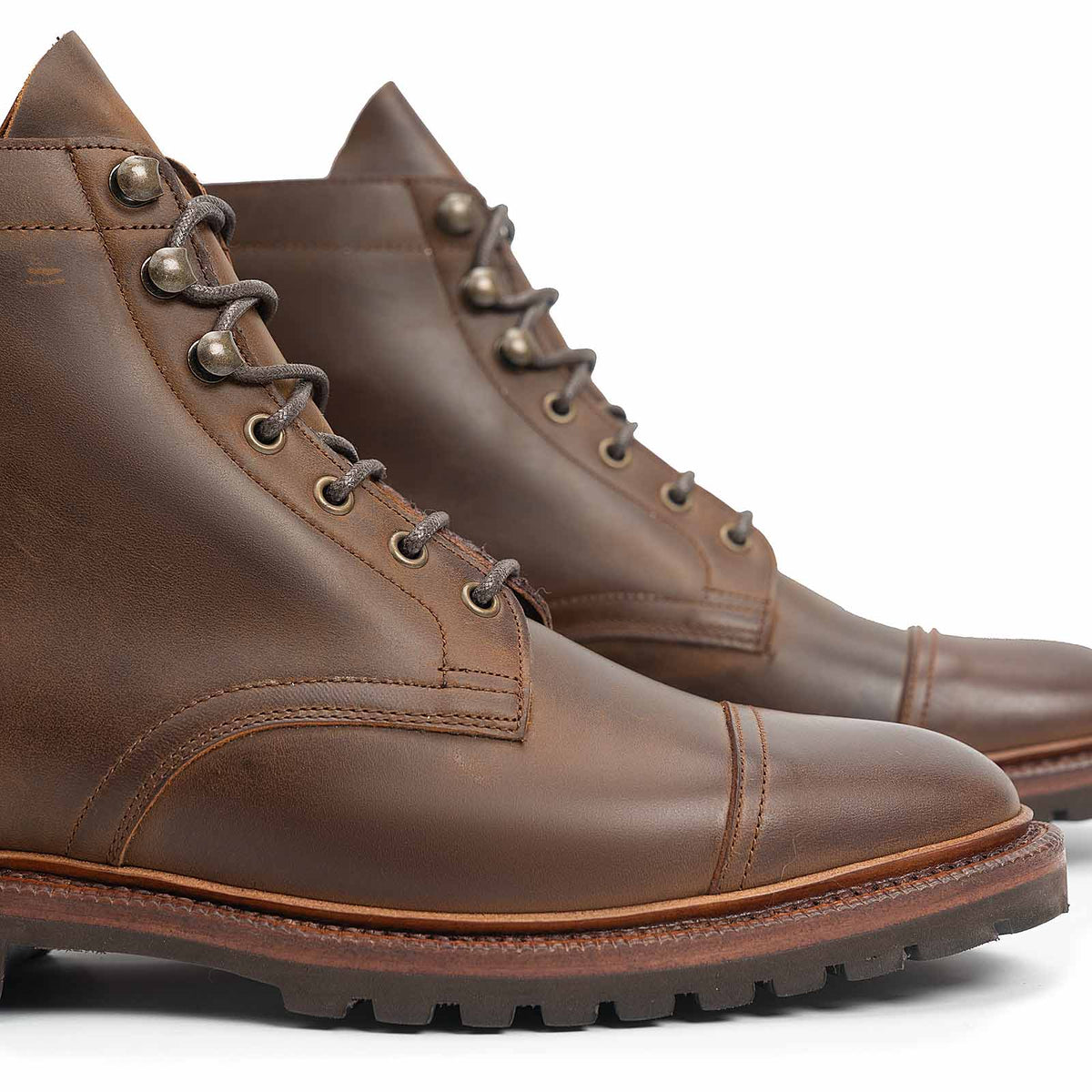 Meermin tobacco waxy calf cap-toe boots, close-up side profile showing lace eyelets, hardware, and lugged sole detail