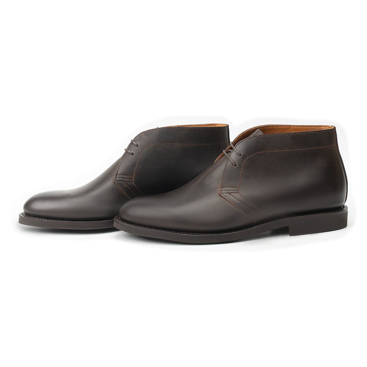 Meermin brown waxy calf chukka boots, three-quarter side view showing both pairs, flex Goodyear welted soles visible