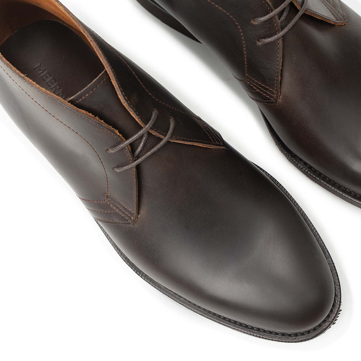Meermin brown waxy calf chukka boots, close-up top view of toe caps and lacing detail on both shoes
