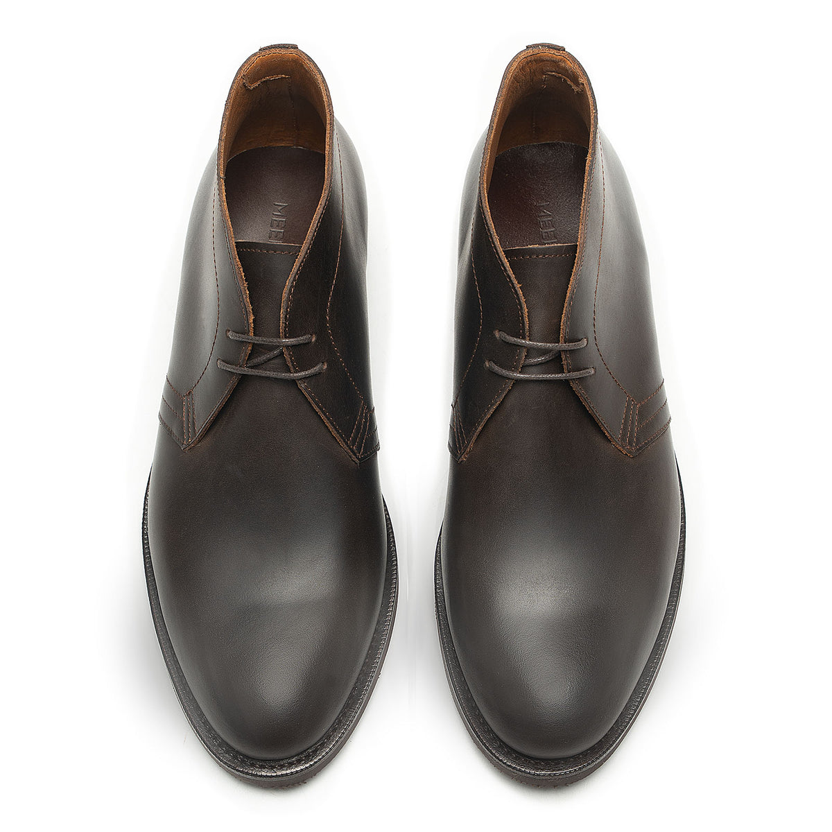 Meermin brown waxy calf chukka boots, top-down view of the pair showing lace detailing and rounded toe shape