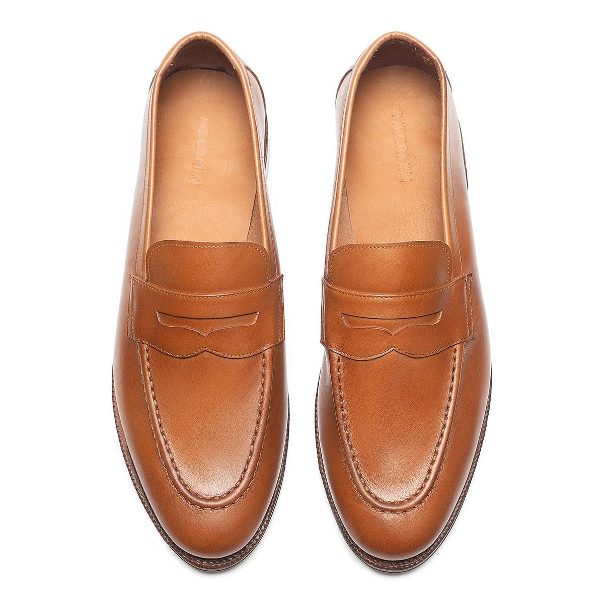 Meermin tan antique calf penny loafers, top-down view of both shoes showing round toe and saddle strap detail