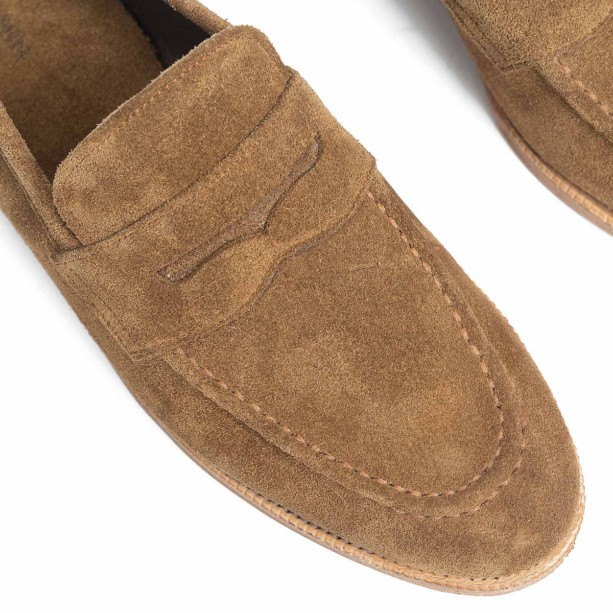 Meermin Atacama suede penny loafers, close-up top view of toe and saddle stitching detail
