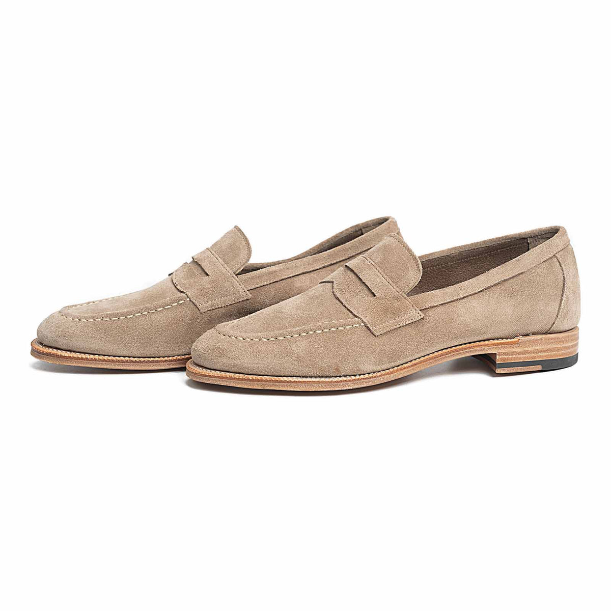 Meermin taupe suede penny loafers, side-by-side three-quarter view showing flex Goodyear welt and leather sole detail