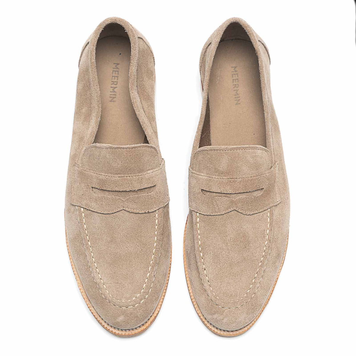 Meermin taupe suede penny loafers, top-down view of both shoes showing the unlined interior and apron stitching