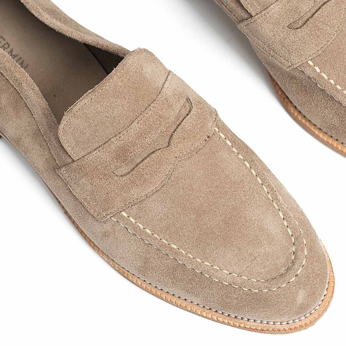 Meermin taupe suede penny loafers, close-up top view of both toes showing saddle stitching and unlined construction