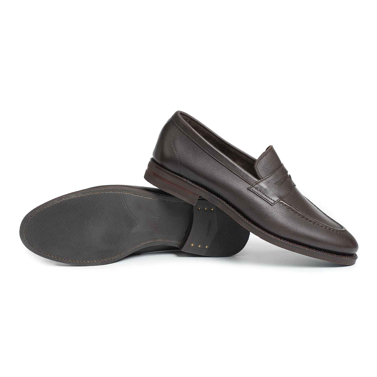 Meermin brown softcalf penny loafers, paired side by side with one shoe overturned to reveal the city rubber sole