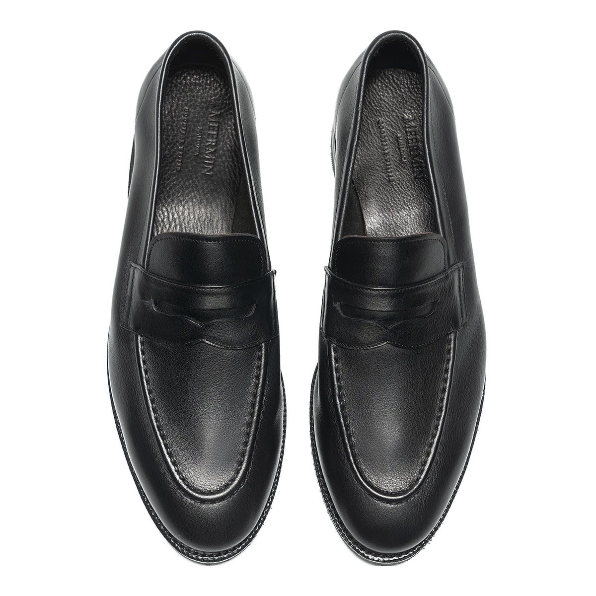 Meermin black softcalf penny loafers, top-down view of both shoes showing round toe apron and saddle strap detail
