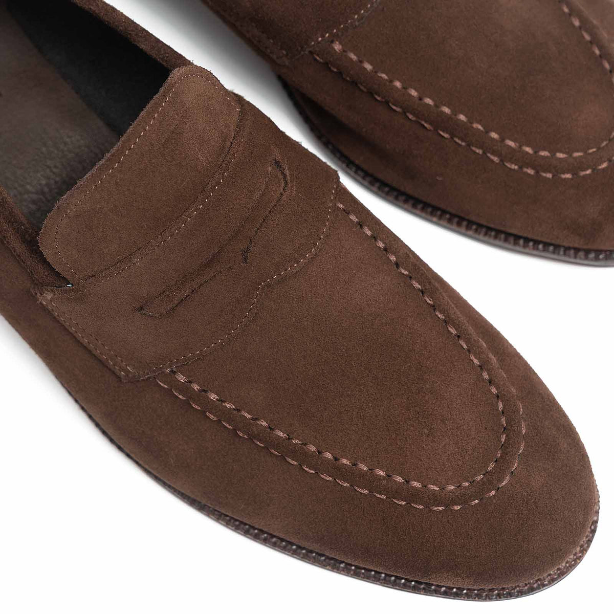 Meermin brown Superbuck suede penny loafers, close-up on toe stitching and strap detail, unlined construction visible