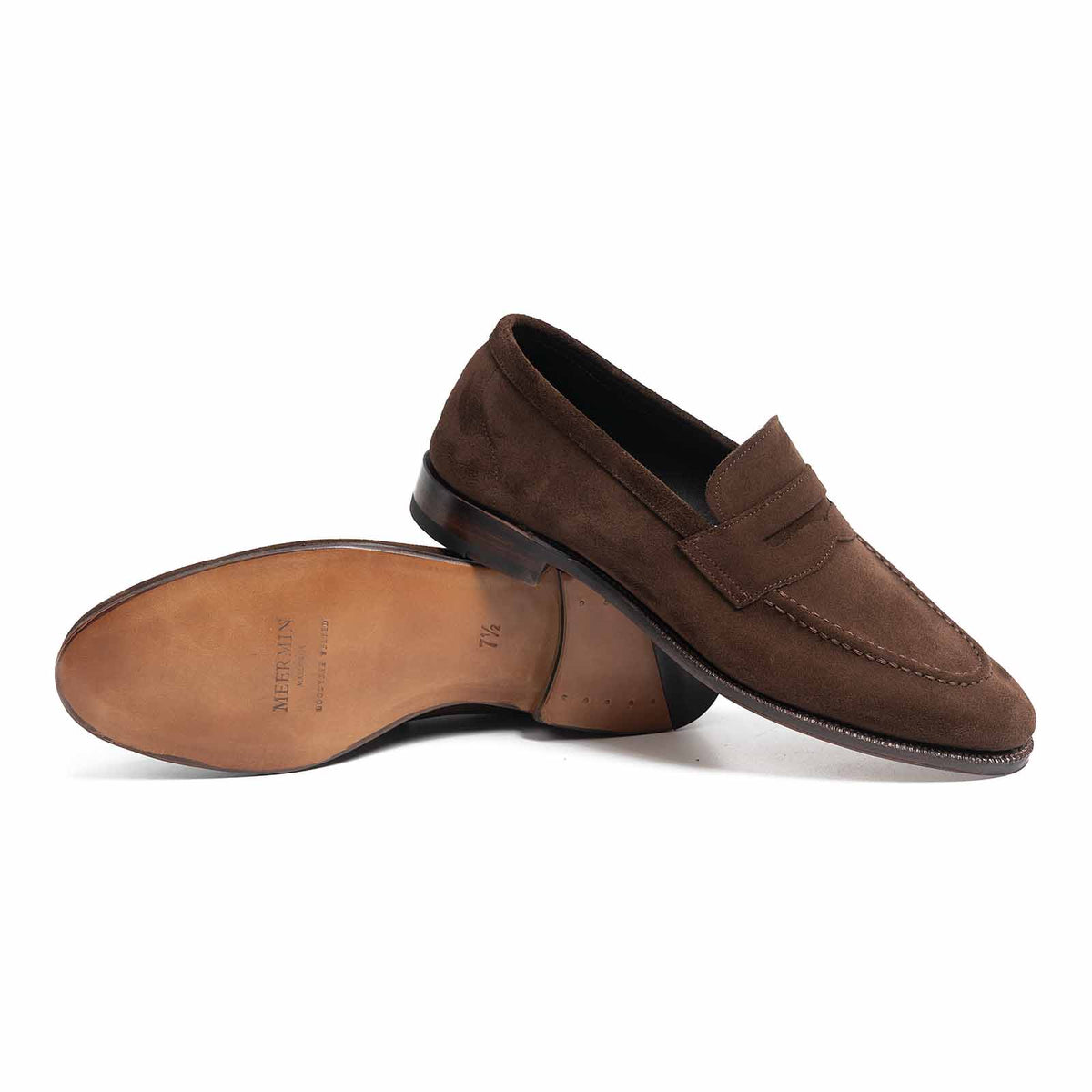 Meermin brown Superbuck suede penny loafer, side profile with sole shown propped against the paired shoe, revealing leather sole and stacked heel