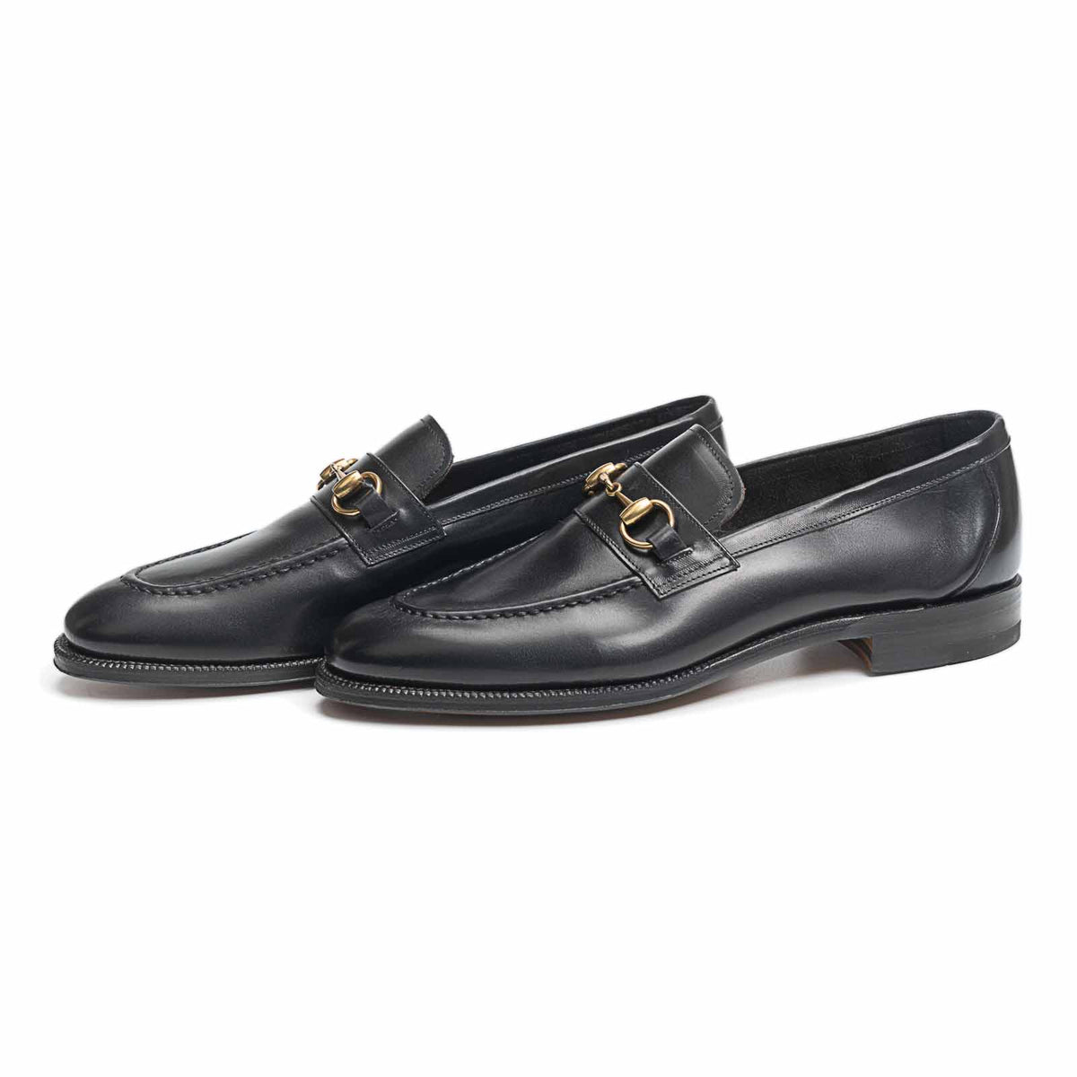 Meermin black boxcalf horsebit loafers, pair shown at three-quarter angle with gold-tone bit hardware and closed channel leather sole visible