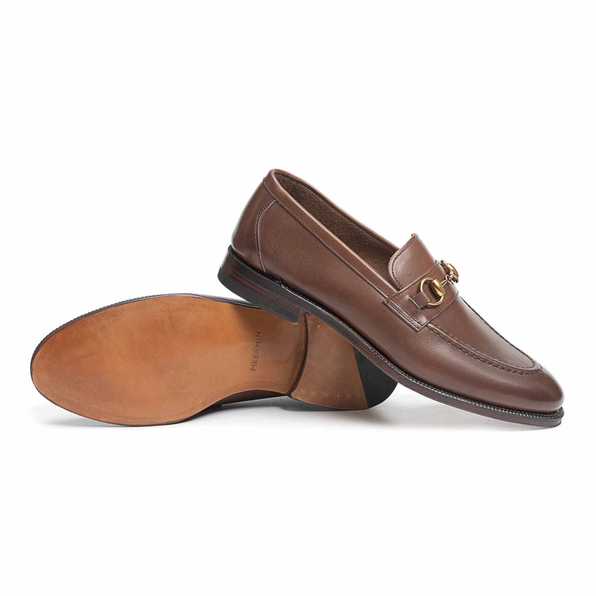 Meermin oak antique calf horsebit loafers, side profile with one shoe overturned showing leather sole and heel construction