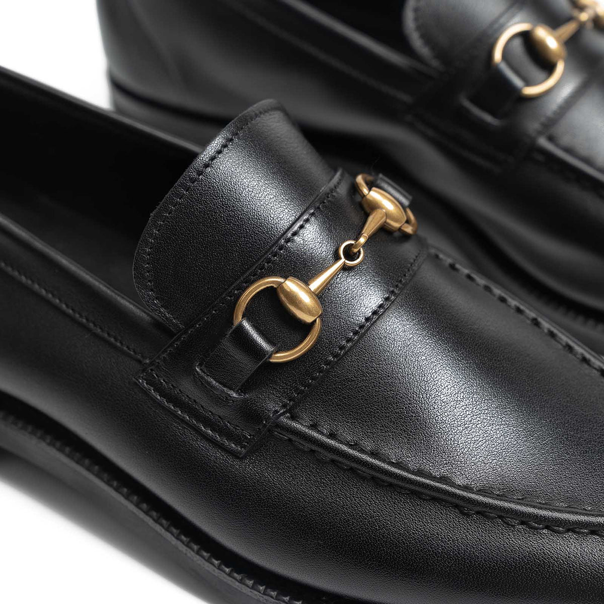 Close-up of the Meermin black softcalf horsebit loafer, focusing on the brass bit hardware and unlined vamp stitching