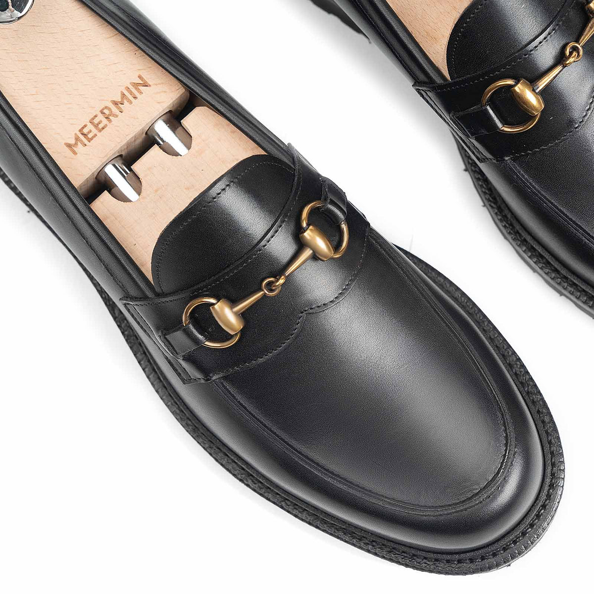 Meermin black boxcalf horsebit loafers, close-up on shoe trees showing brass hardware and apron stitching detail