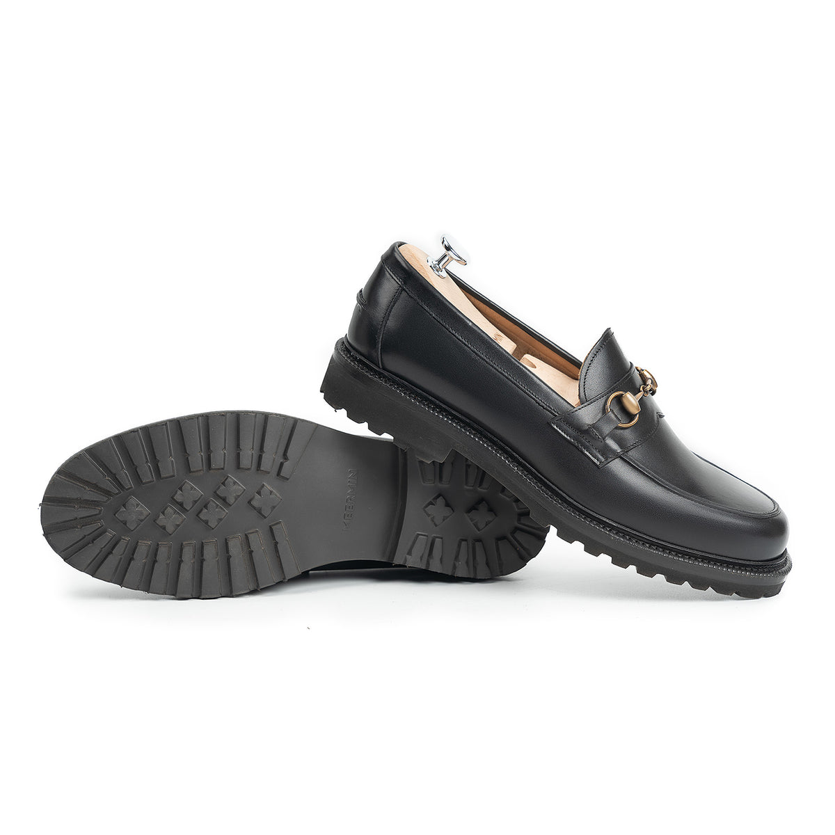 Meermin black boxcalf horsebit loafers, paired shoe on shoe tree with sole and cleated rubber tread of other shoe shown side-on