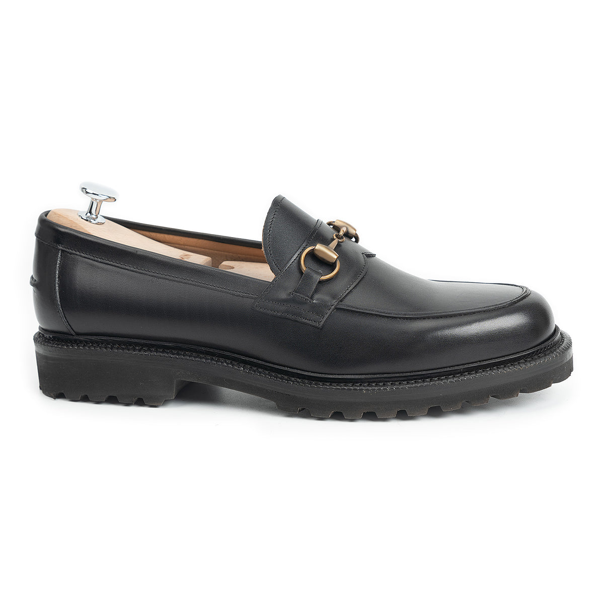Meermin black boxcalf horsebit loafer, side profile on shoe tree, showing brass hardware, apron stitching, and cleated flex Goodyear welted sole