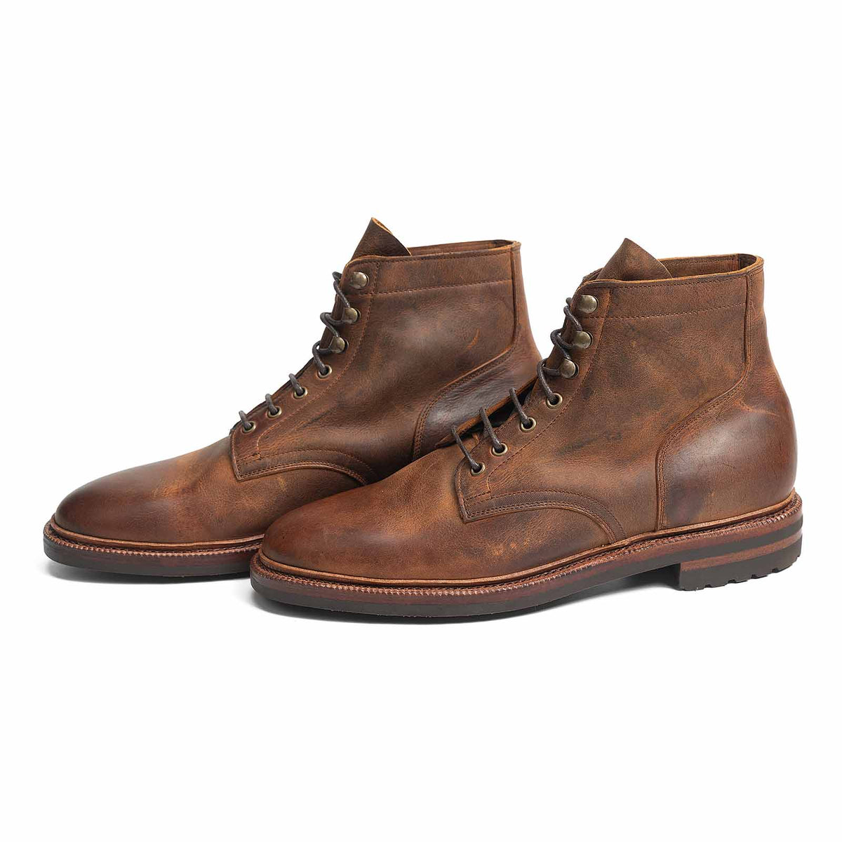 Meermin autumn spice plain toe boots, three-quarter front view showing both pairs, waxy kudu leather grain and lace detail visible