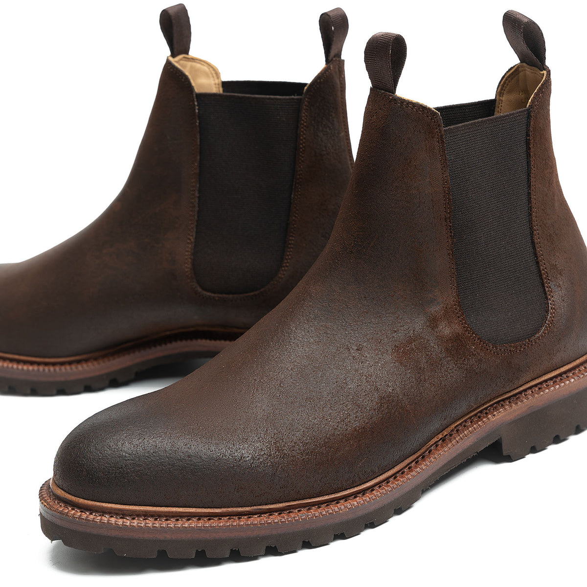 Meermin rust waxy commander suede Chelsea boots, close-up front angle showing elastic side gussets and lugged Goodyear welted sole