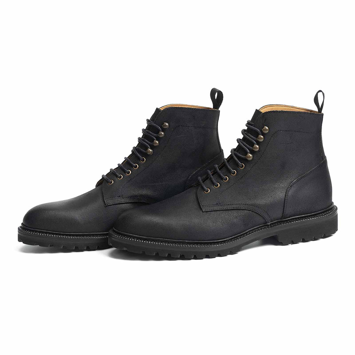 Meermin black waxy commander plain-toe Service boots, three-quarter front view showing lace-up eyelets and cleated rubber sole