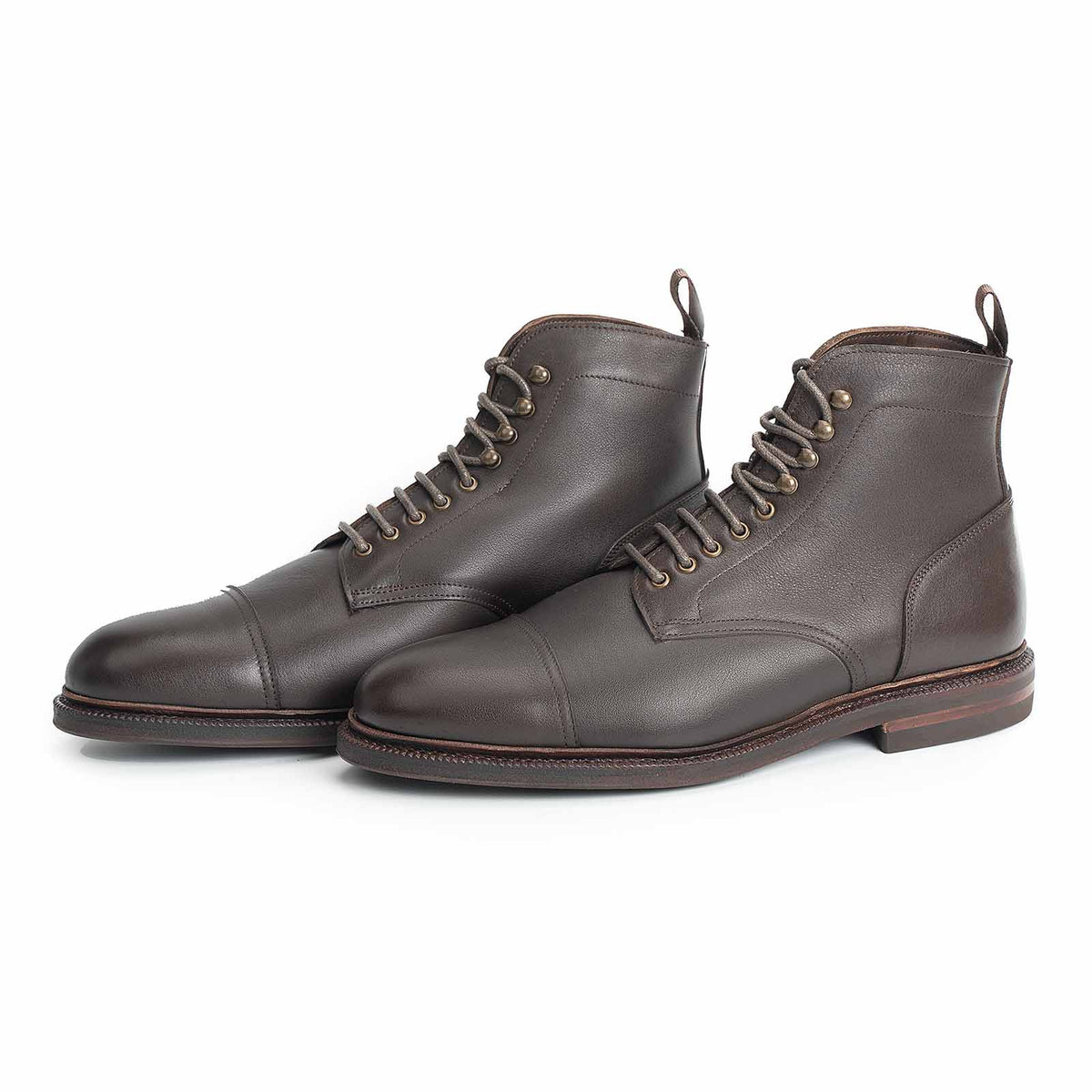 Meermin brown softcalf jumper boots, three-quarter front pair view showing cap-toe stitching, lace hooks, and studded rubber sole